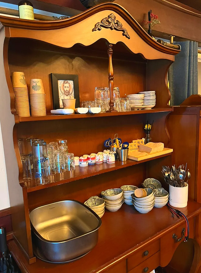 Wood-tone tableware cabinet and charging outlet area