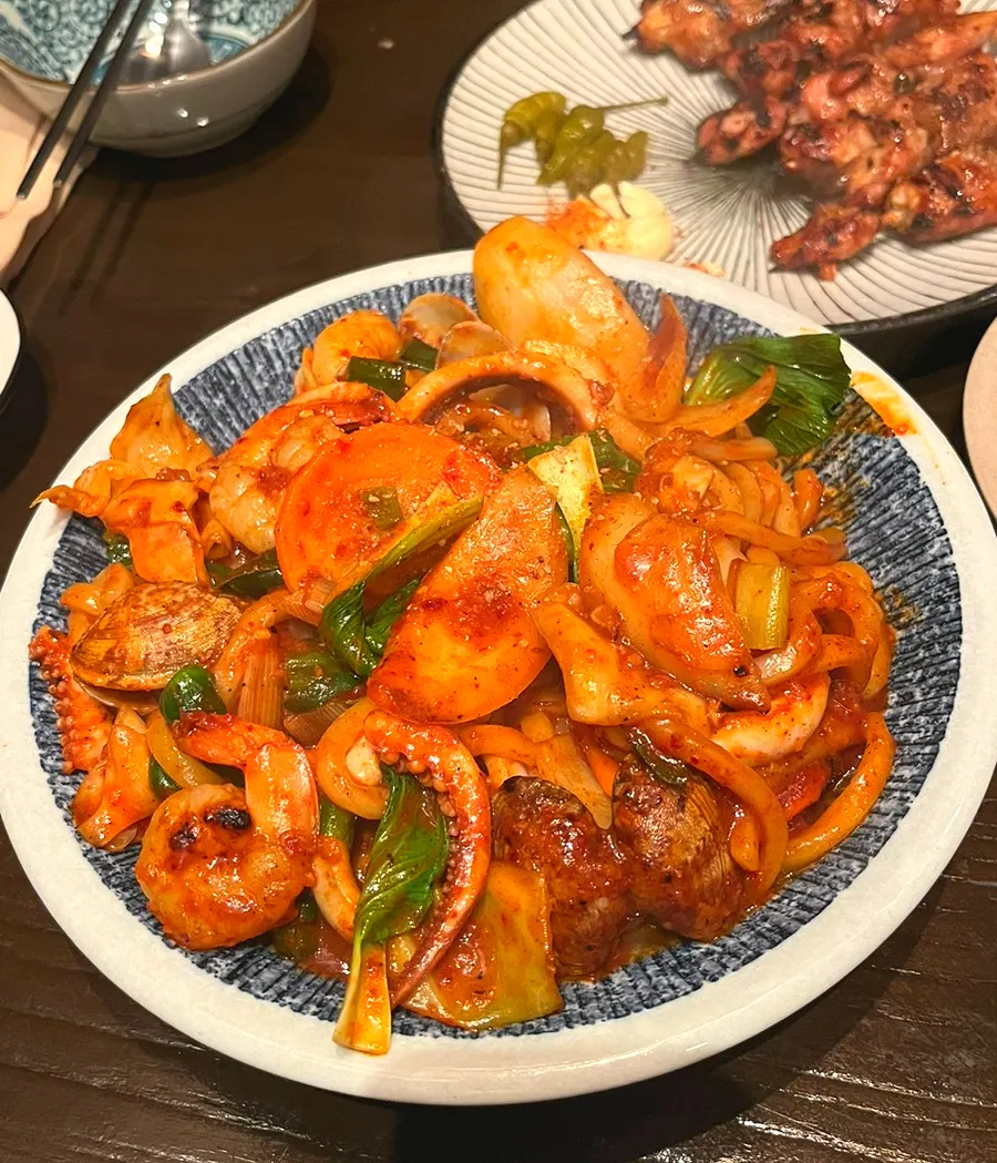 Spicy seafood yakiudon piled generously with seafood and vegetables