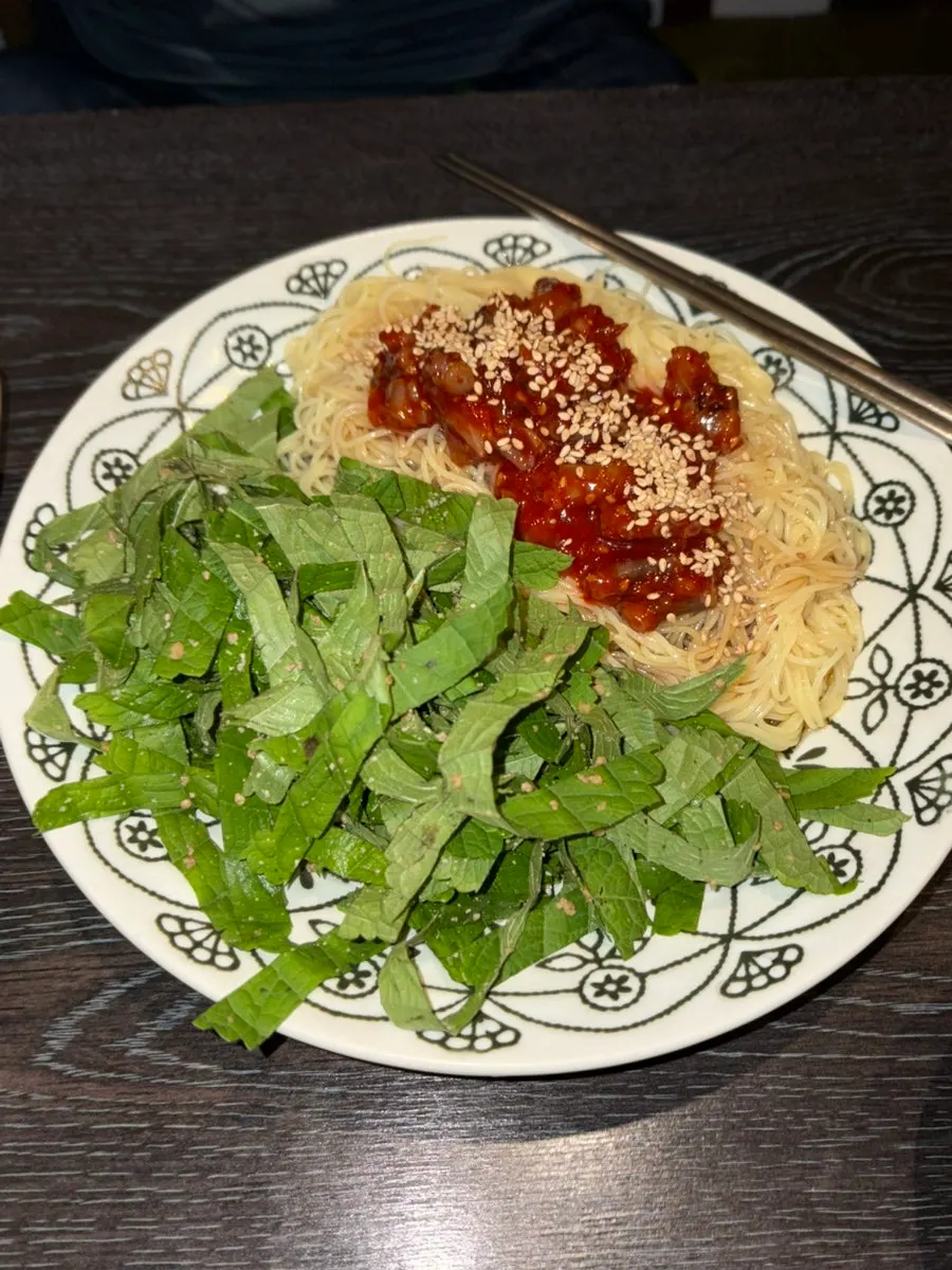 A piece of lamb shoulder rack dipped in sauce