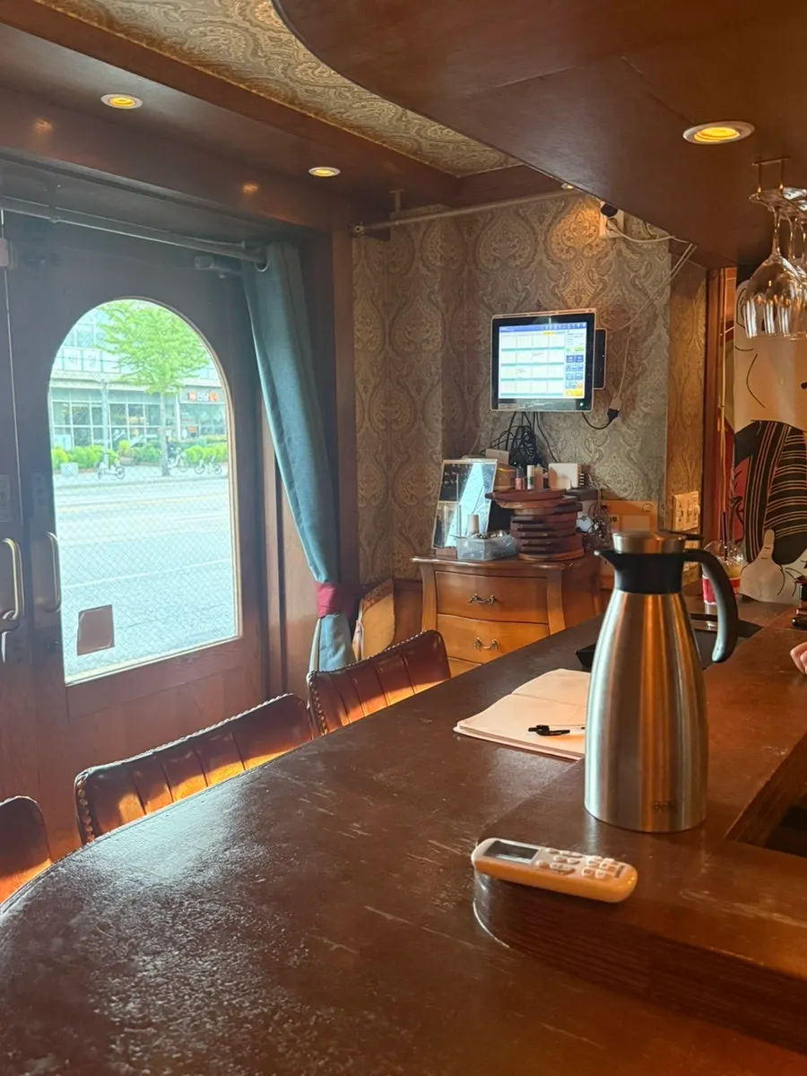 Seating area with wood-toned walls and lighting