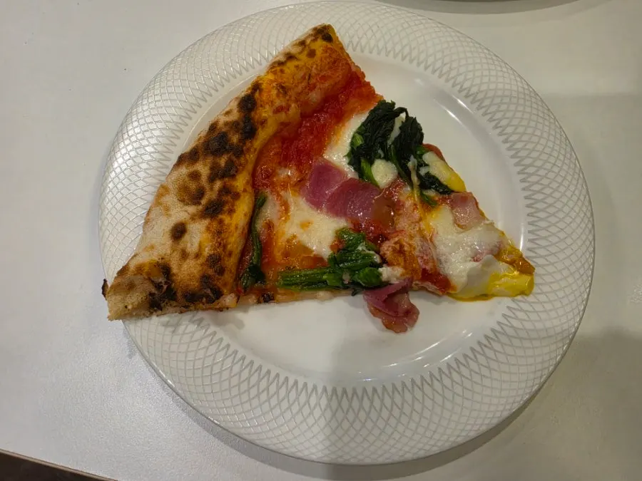 Soft-boiled egg yolk on top of the pizza
