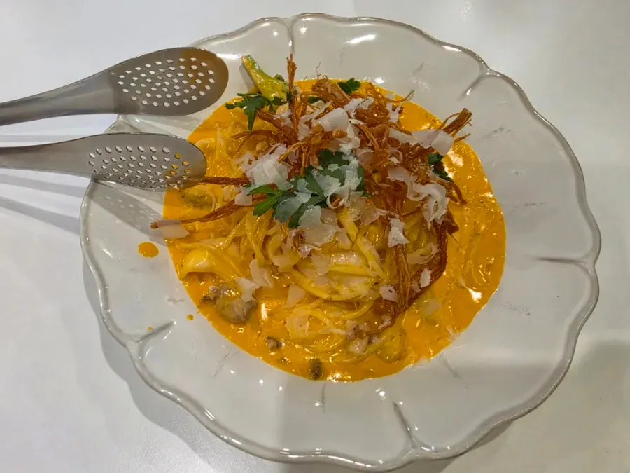 A plate of rosé pasta topped with seafood