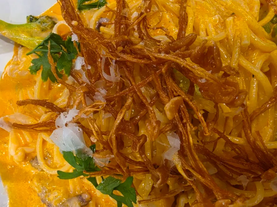 Rosé pasta with visible shrimp and cuttlefish