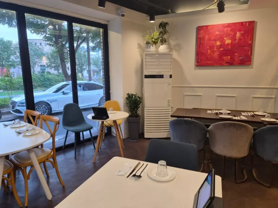 Interior seating near the window with a view of trees