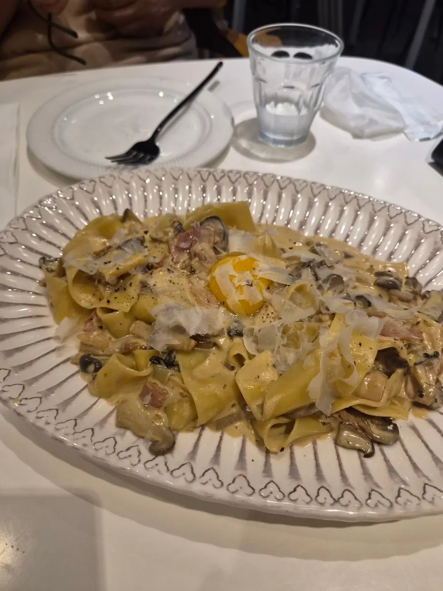 Pasta, pizza, and Coke set out on the table