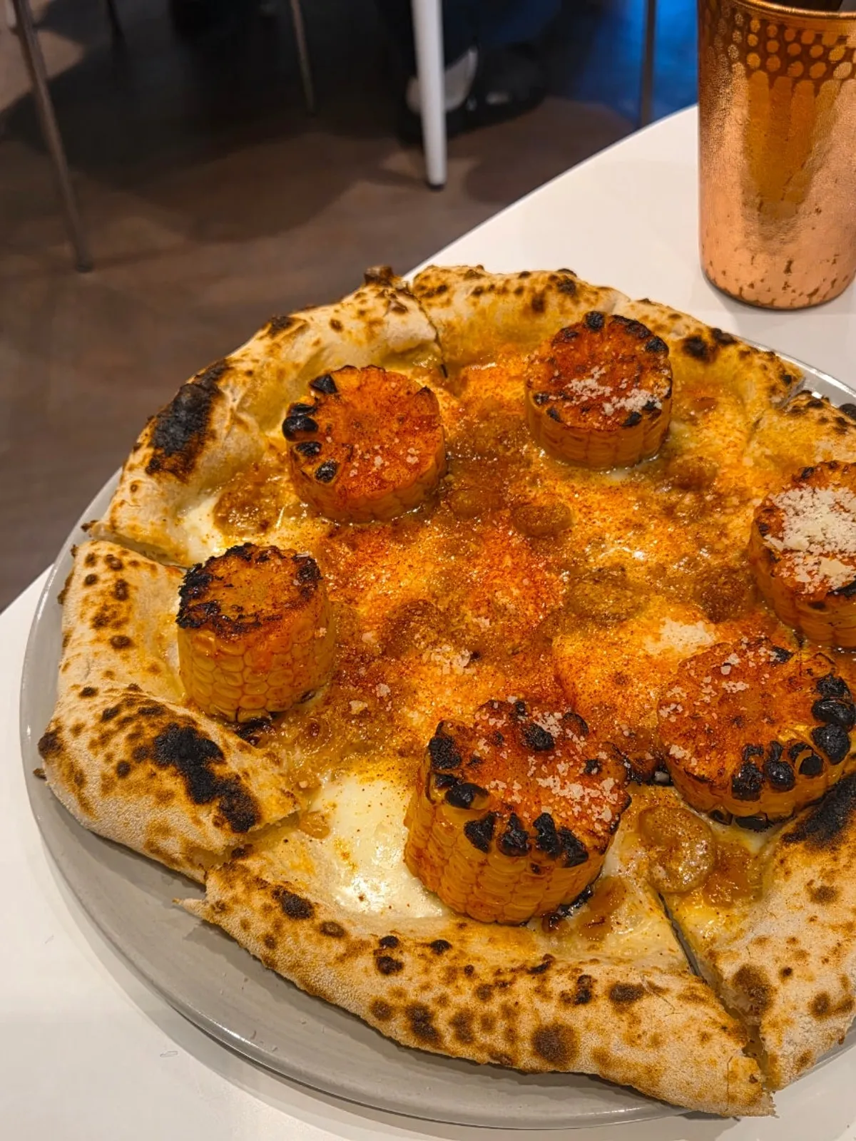 Corn pizza topped with whole corn kernels