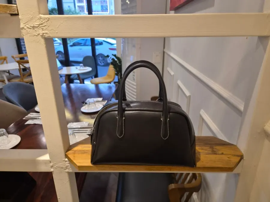A shelf next to the seating good for storing bags
