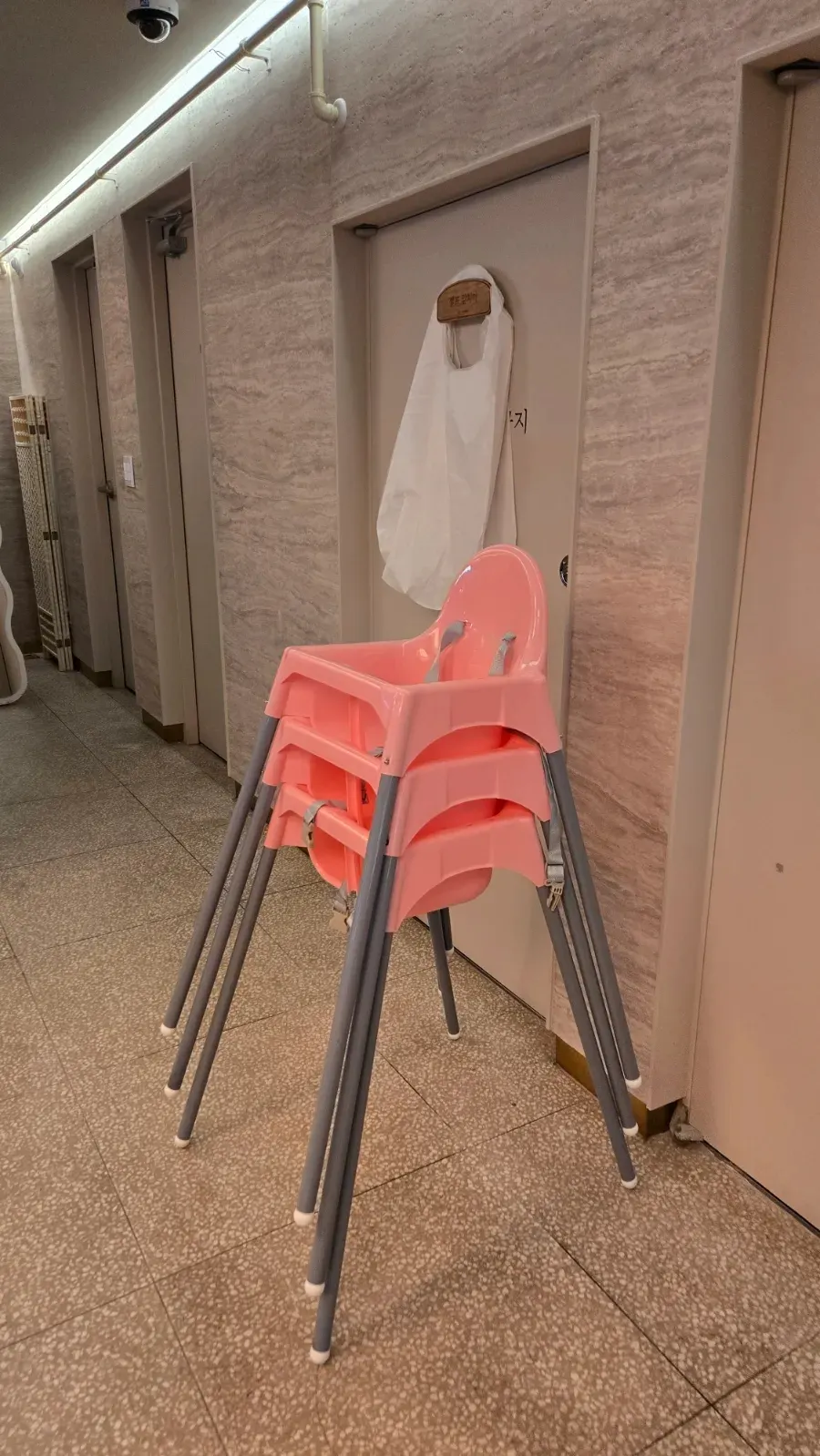 A baby chair placed in a corner of the restaurant