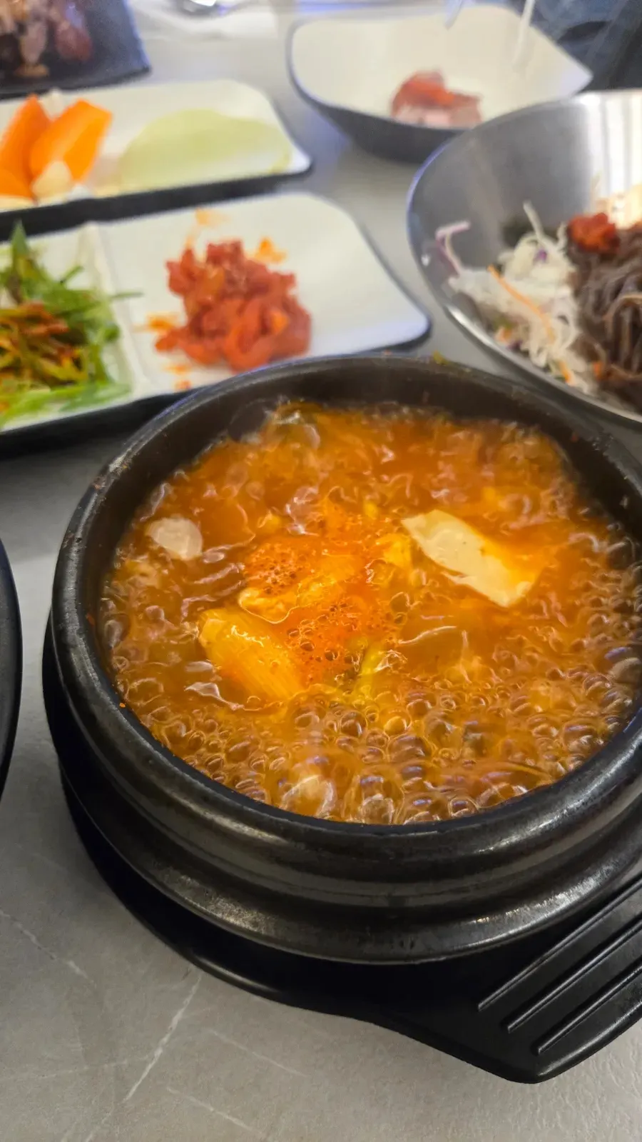 Spicy sundubu-jjigae topped with egg