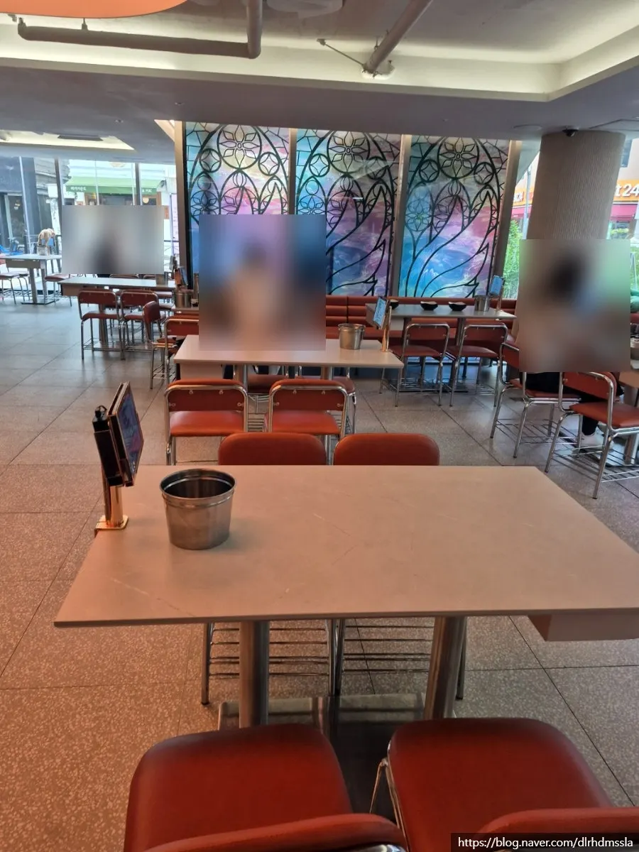 Dining seats by the striking glass windows at Narae Jokbal