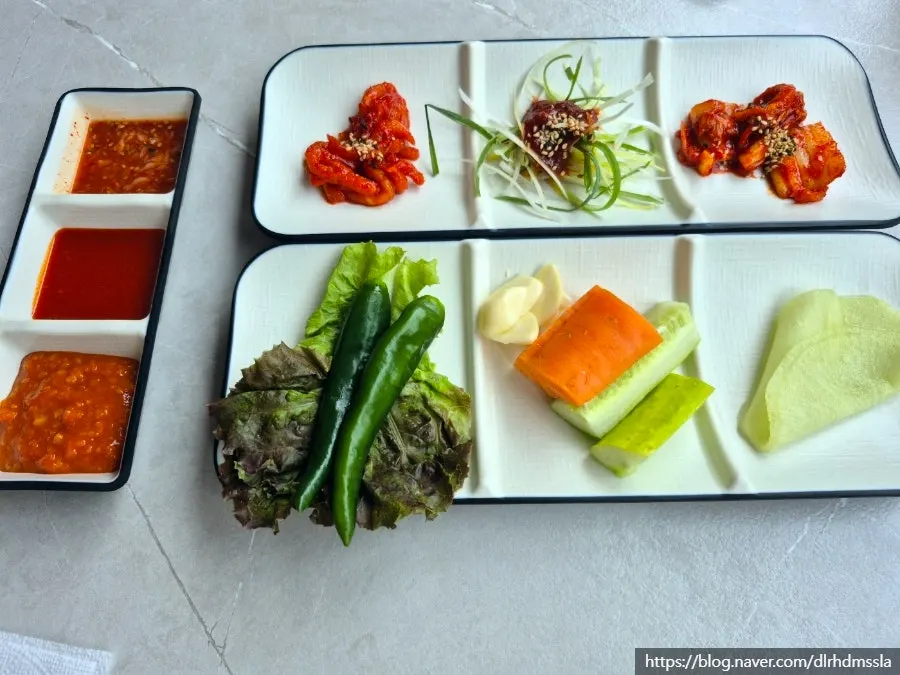 Table setting with makguksu and sundubu-jjigae