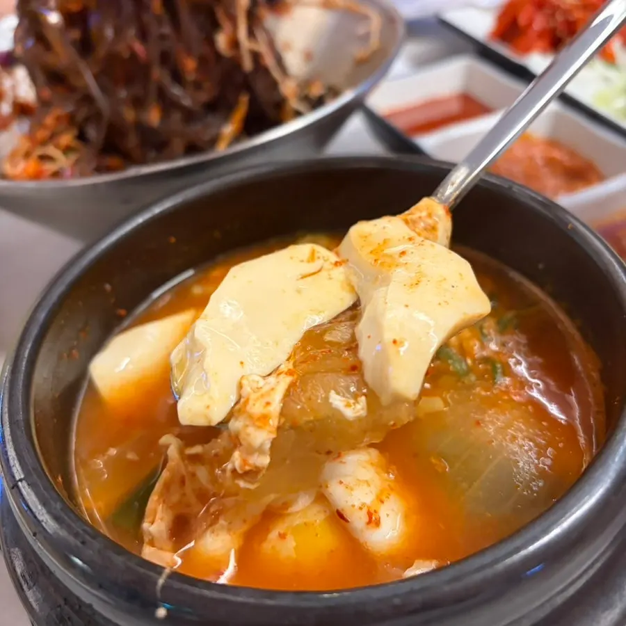 Table with sundubu-jjigae and makguksu together