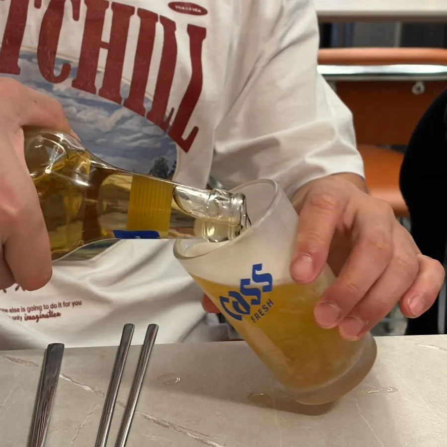 A bottle of beer ordered alongside the bossam