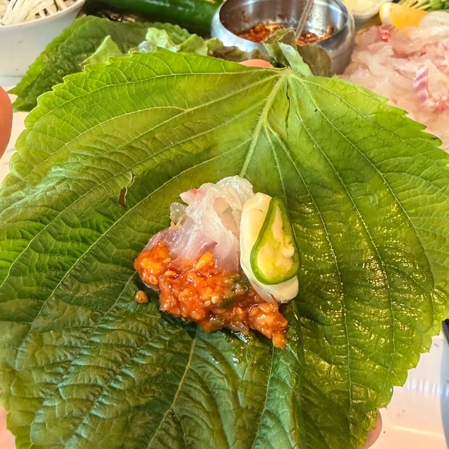 Perilla leaf wrap with sea bream sashimi and makjang