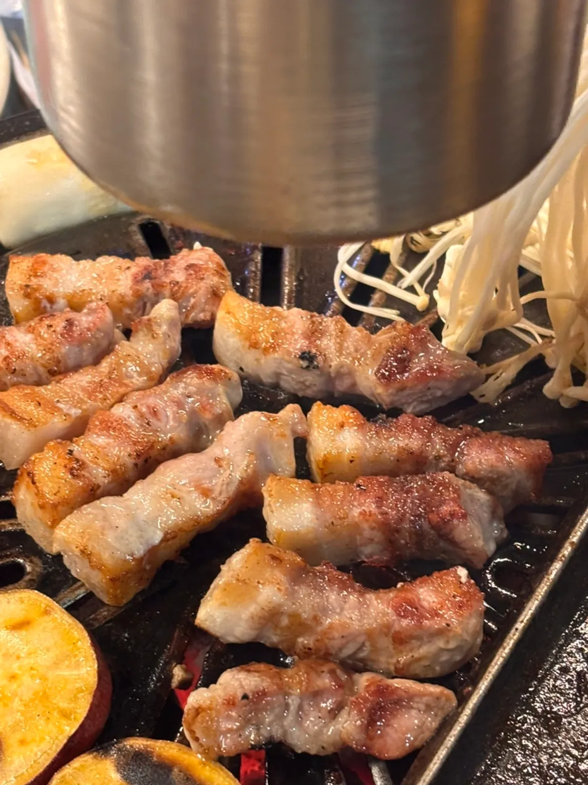Chewy kkodeulsal and pork belly on the grill