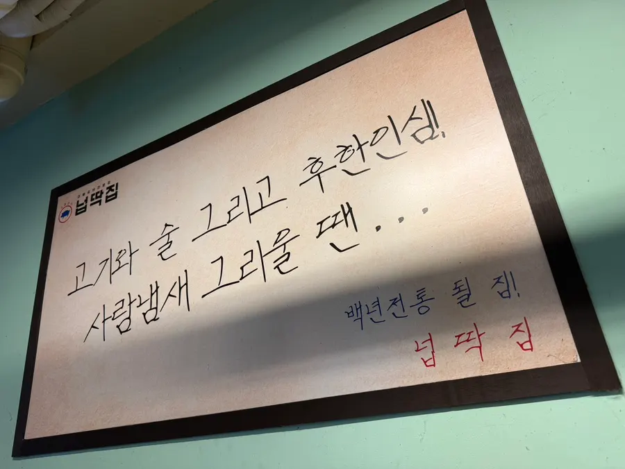 Store sign explaining the origin of the Neopttakjip name
