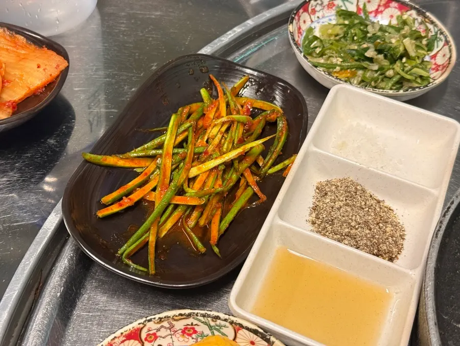 Meat table setup with ssamjang, salt, oil, and perilla powder