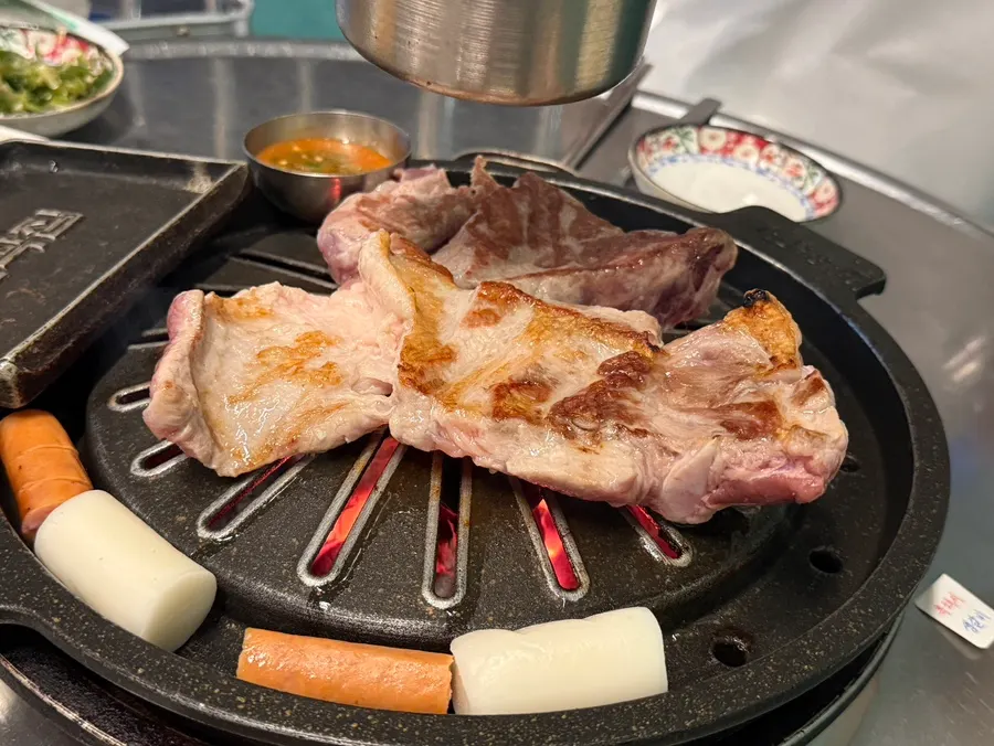 Thick raw ribs grilling over high heat
