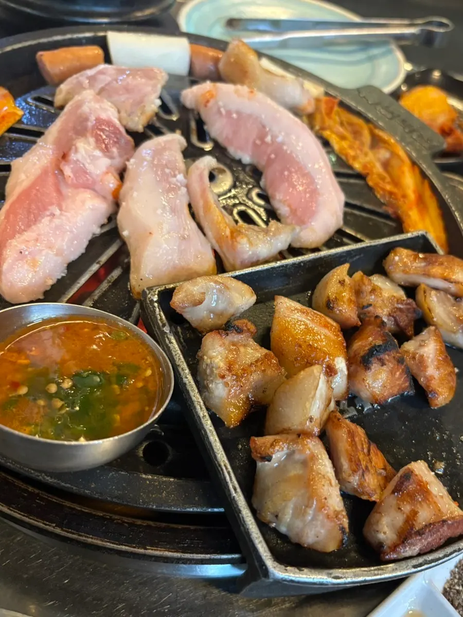 Rice cake sticks cooked alongside the grilled meat