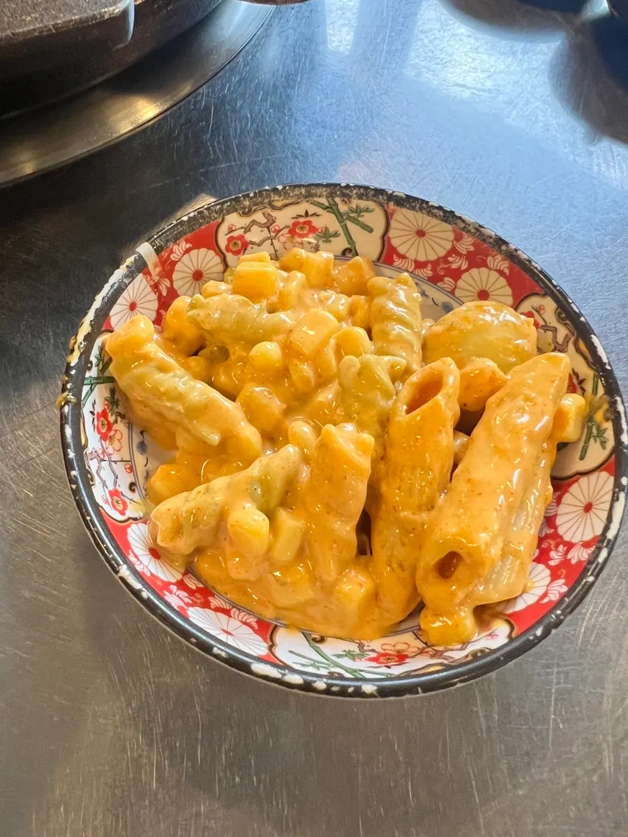 A plate of yellow-tinted curry-flavored macaroni salad