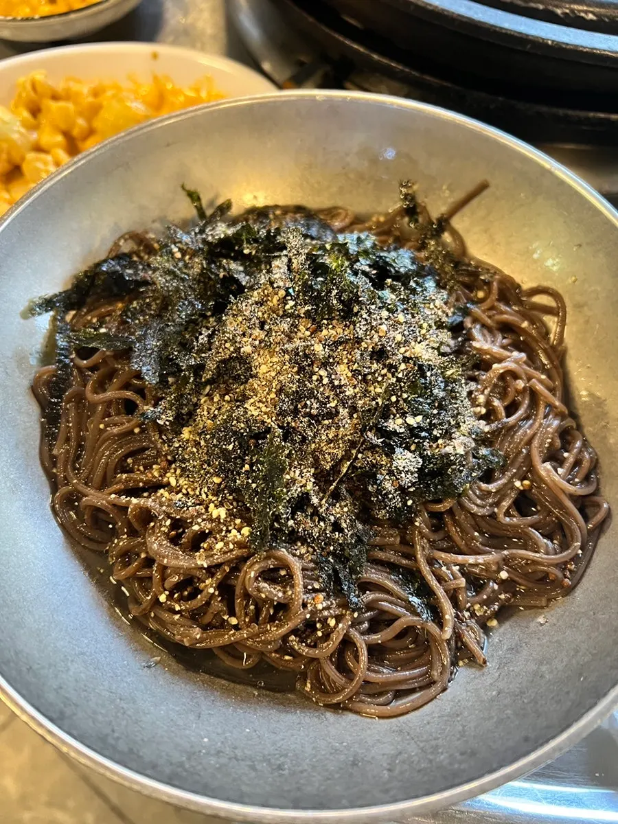 Perilla oil buckwheat noodles topped with seaweed flakes and sesame seeds