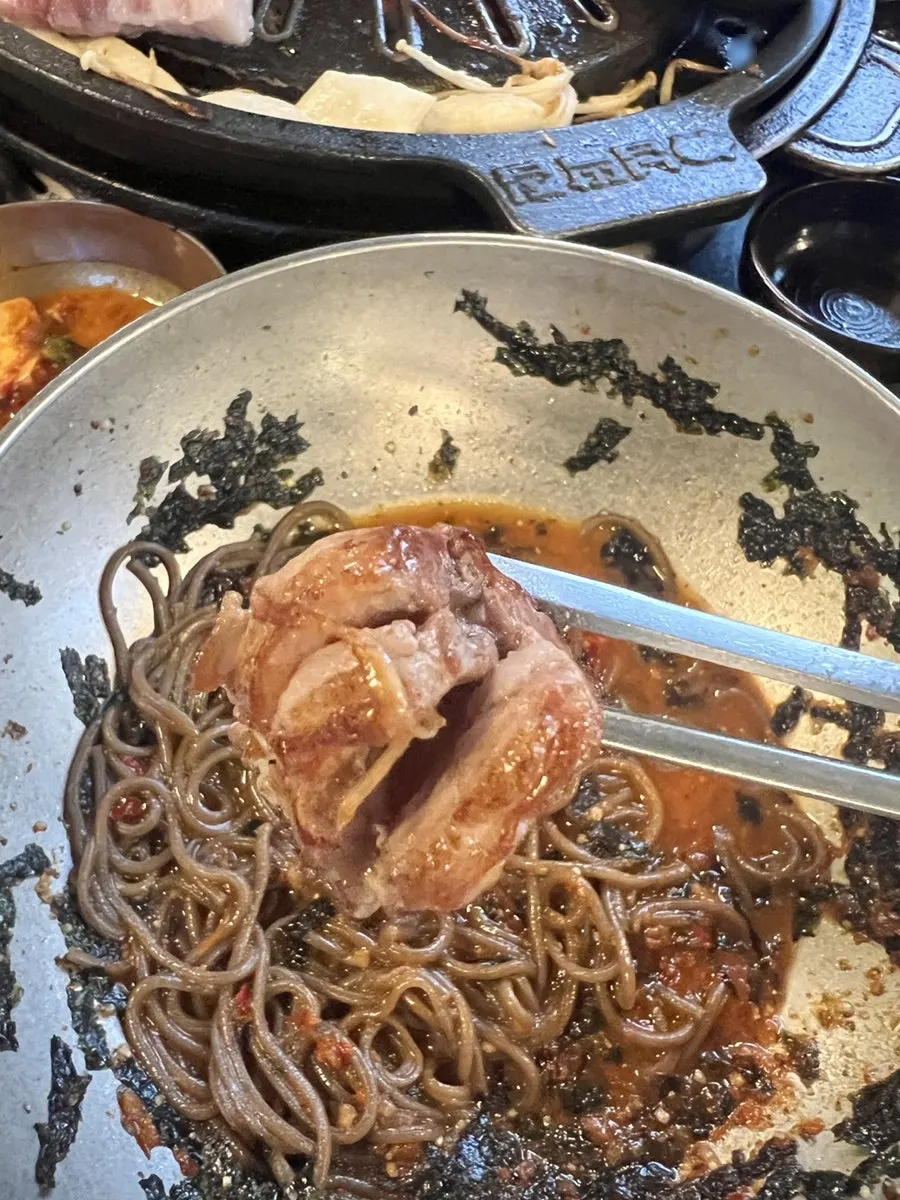 Grilled meat placed on top of the perilla oil noodles