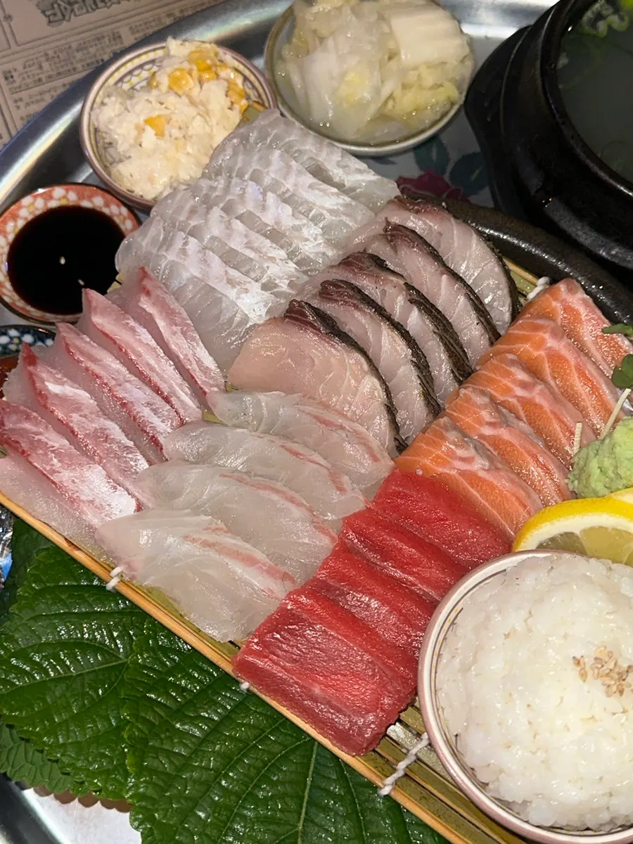 A piece of aged sashimi showing its chewy texture