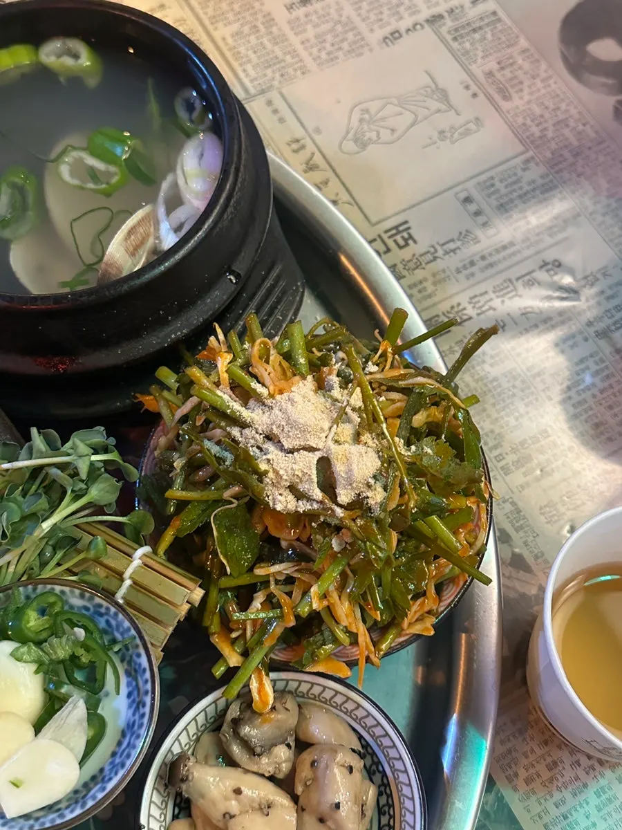 Side dishes of minari cabbage salad and sautéed mushrooms