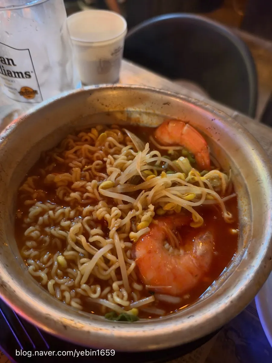 Noodles and toppings lifted out of the ramyeon