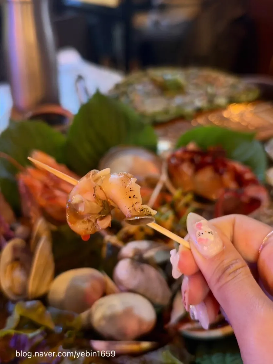 Seafood and side dishes laid out at the outdoor tent table