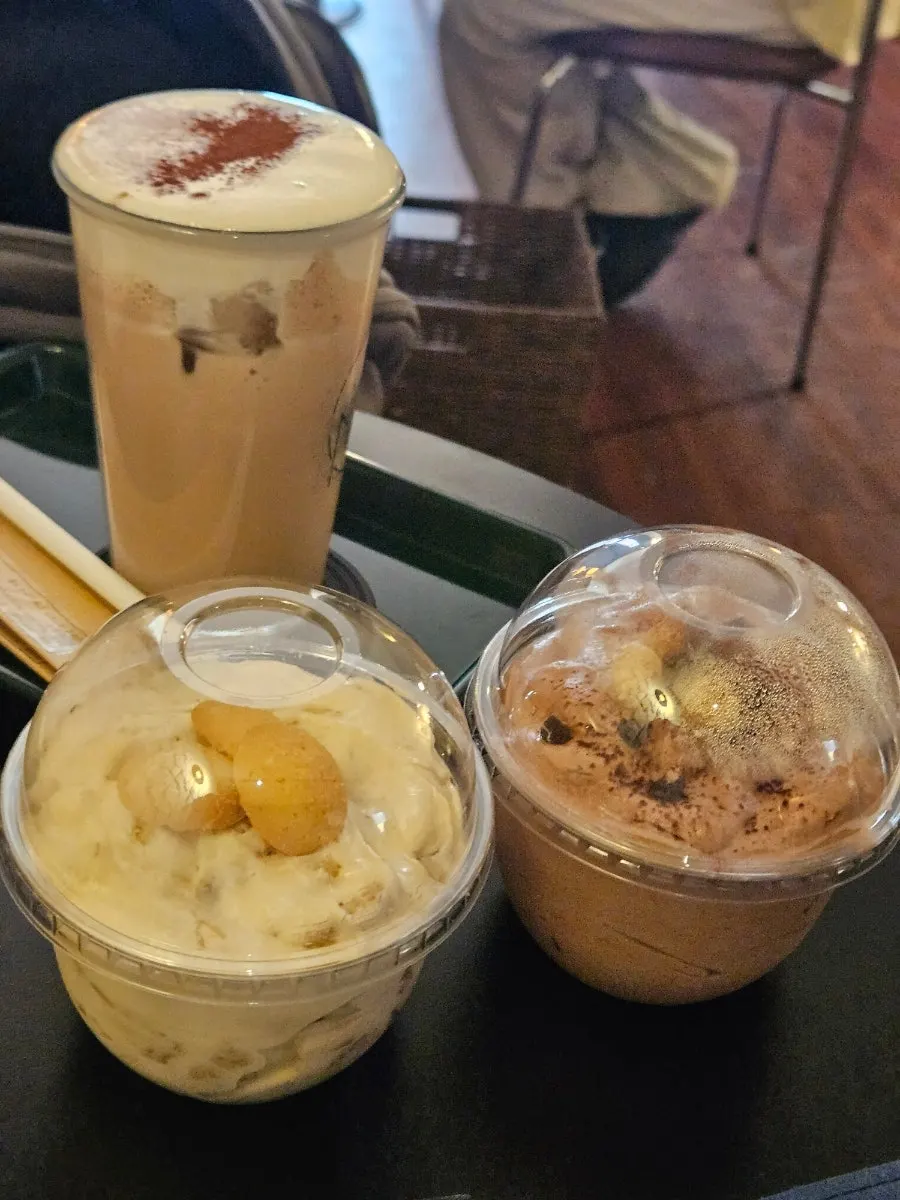 A tray with two bowls of pudding and a Nerdy Cream Mocha