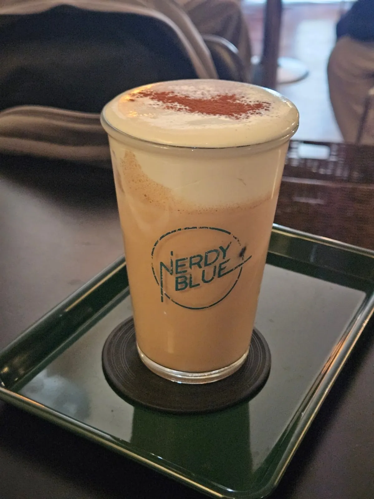 Taking a first taste of the cream on top of the Nerdy Cream Mocha