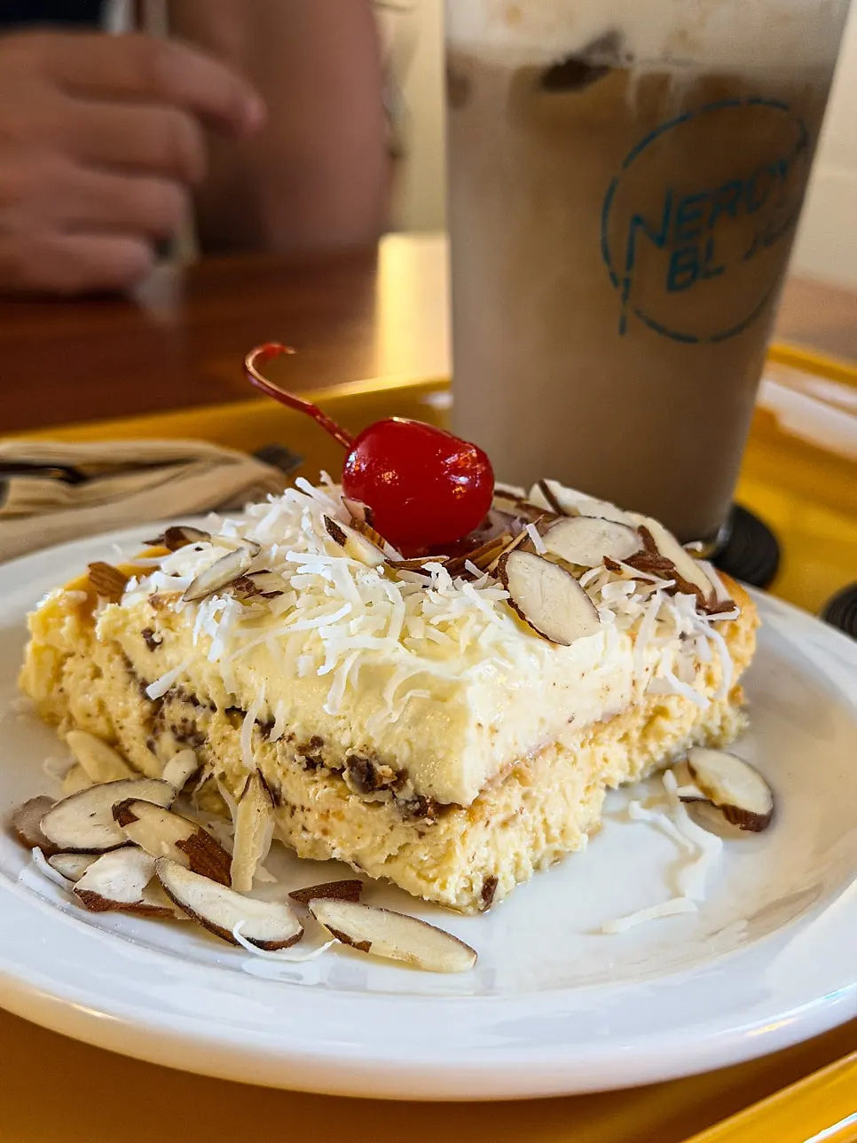 Cheesecake topped with almonds and dried coconut