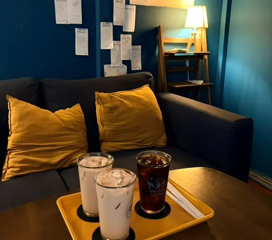 A cup of cold brew and milk tea on the table