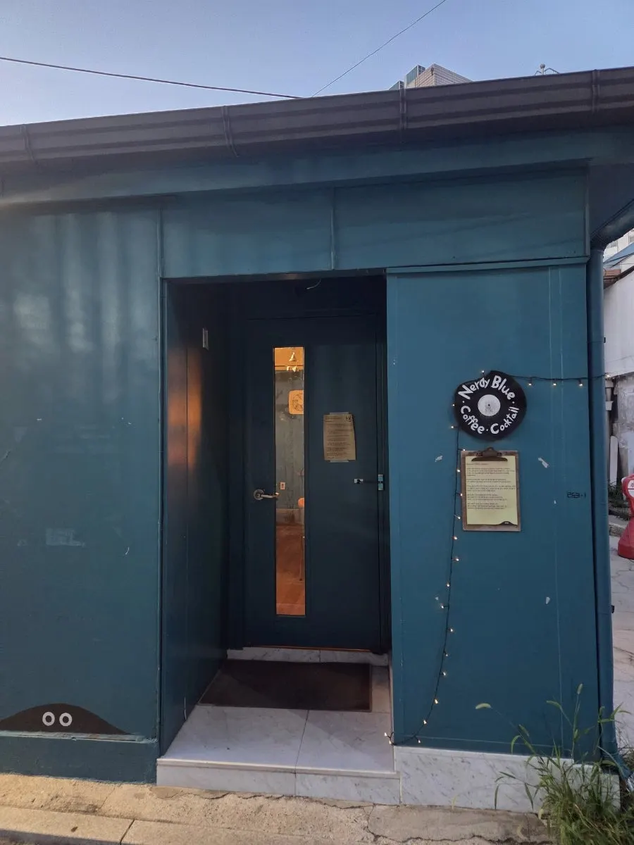 Café entrance lit up at dusk