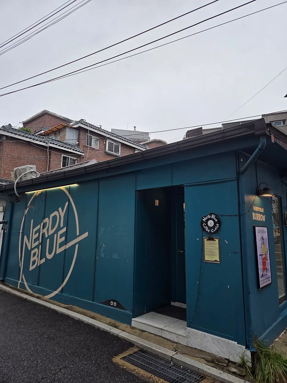 Teal exterior and entrance of Nerdy Blue Burrow in Wangsimni