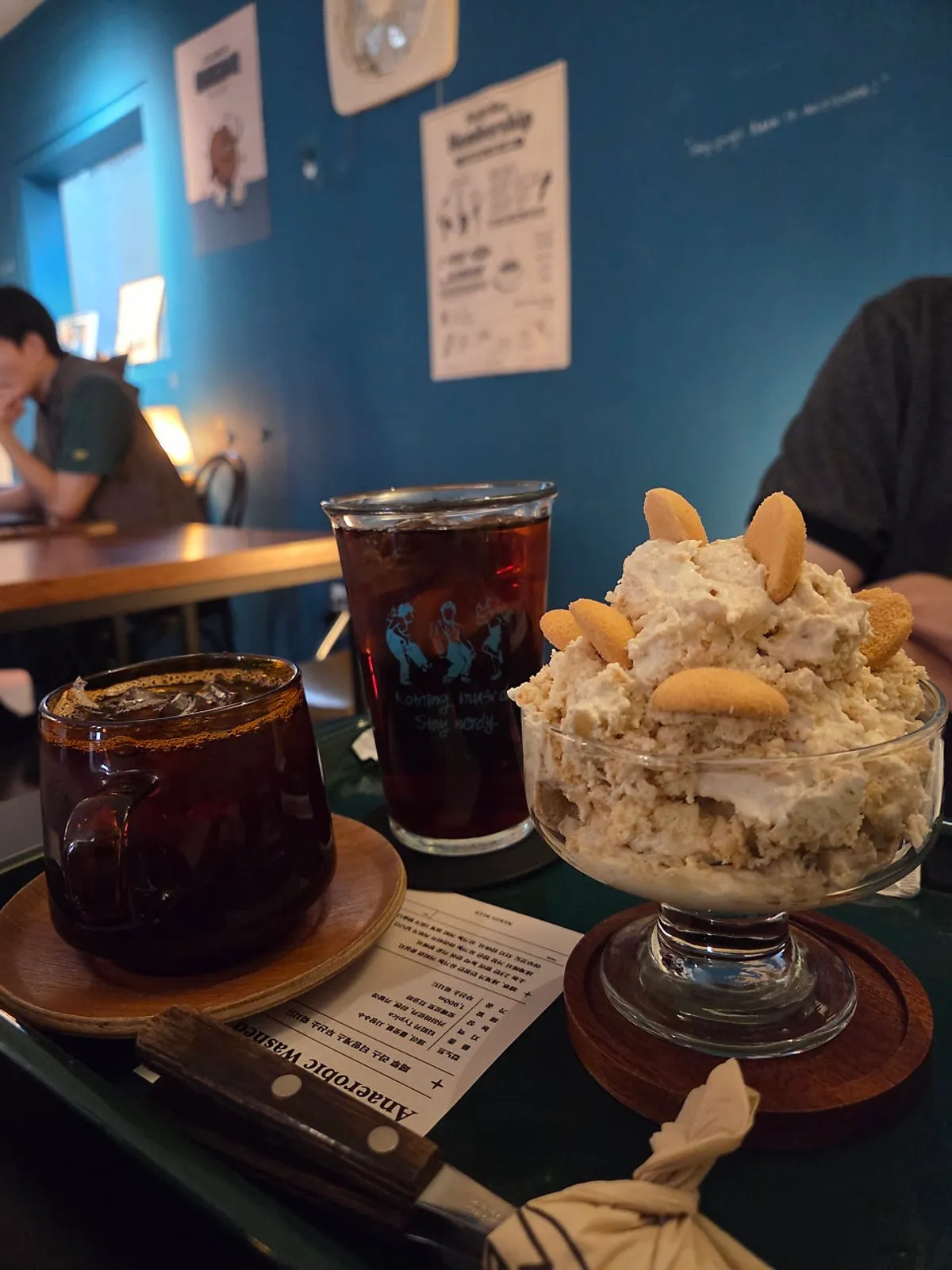 Table at Nerdy Blue Burrow set with coffee and dessert