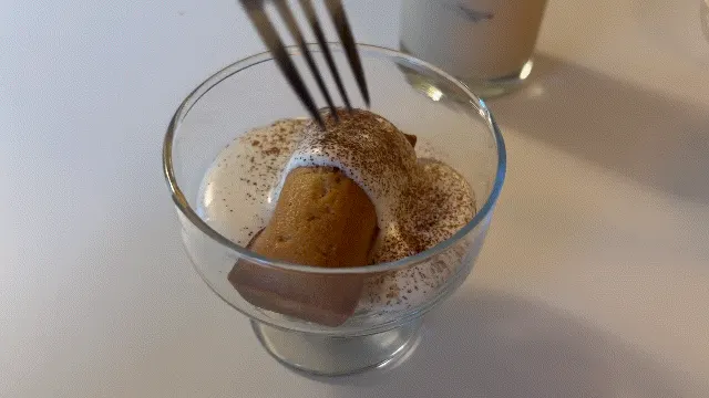 Classic financier dipped into cream