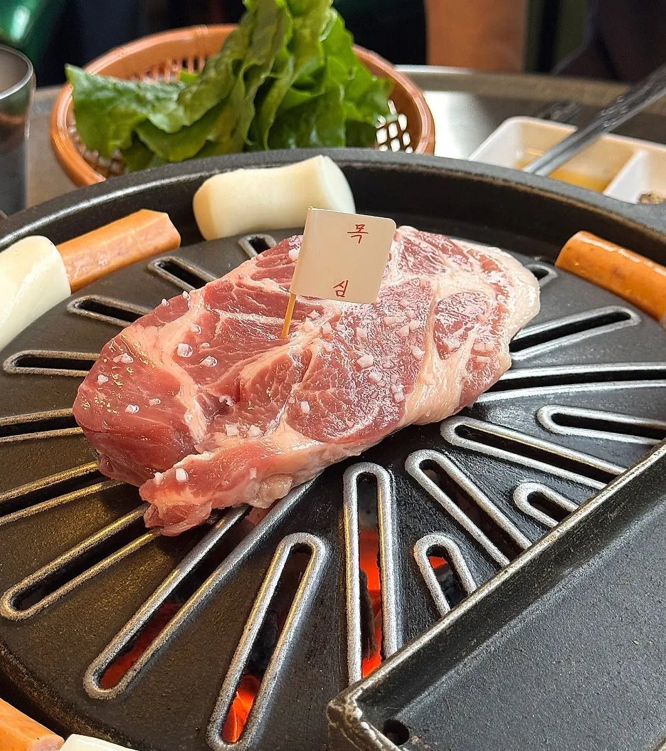 Neck meat placed on the grill first by staff