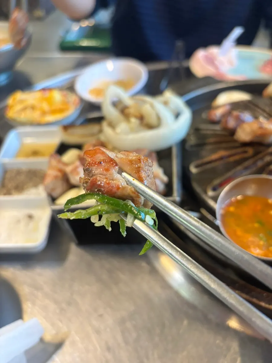 A slice of grilled meat topped with aged kimchi