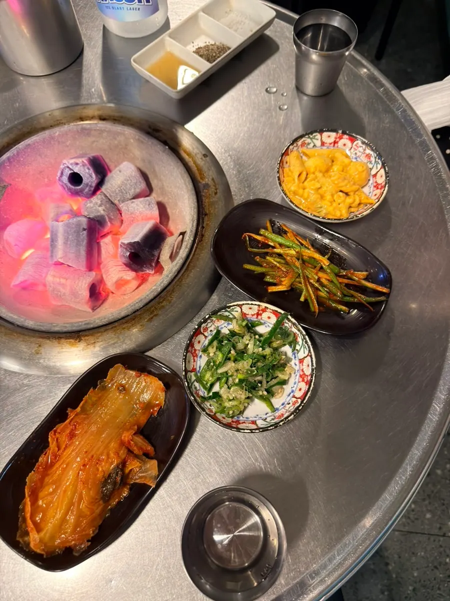 Side dish setup at Neopttakjip including pasta, kimchi, and shredded scallions