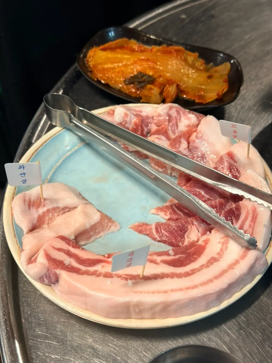 Samgyeopsal and specialty cuts grilling on the mixed grill