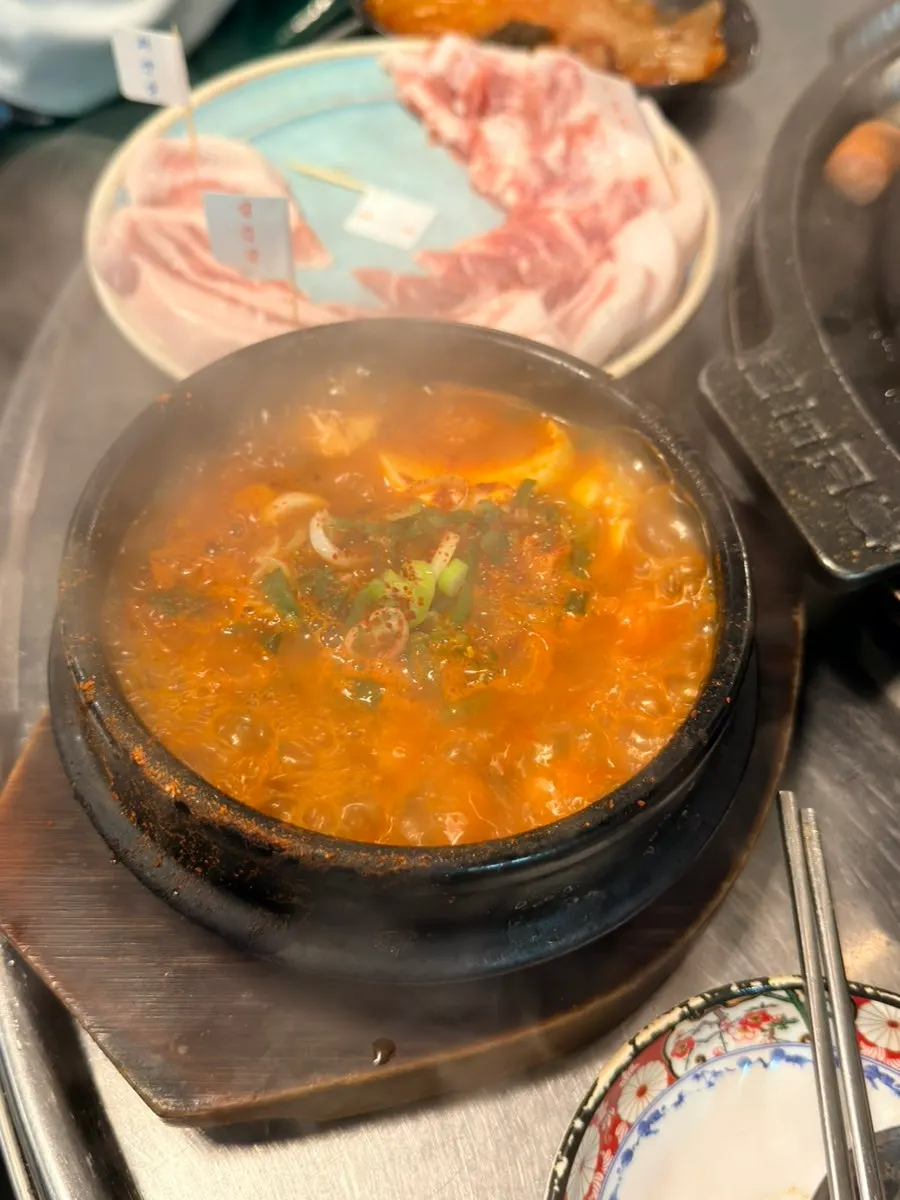 Spicy sundubu jjigae ordered alongside the meat