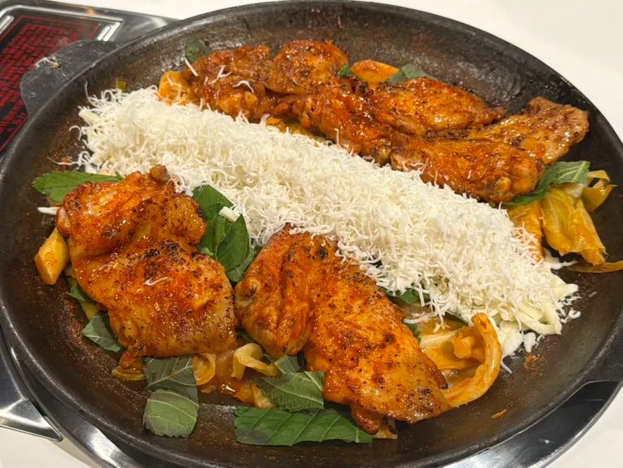 Cheese bomb dakgalbi piled high with cheese in the center