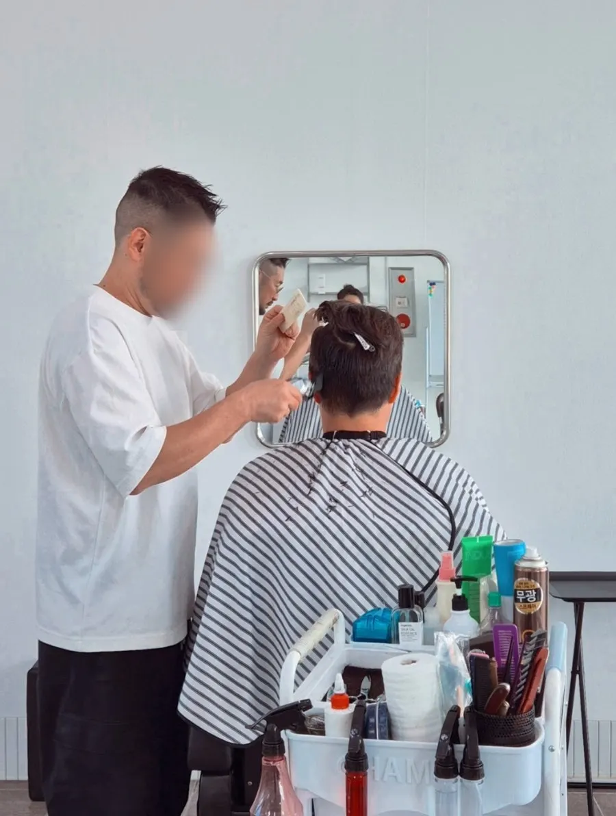 Trimming the back hair with scissors
