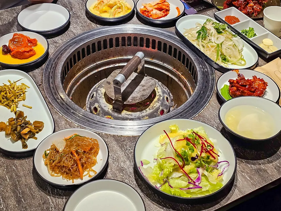 Basic side dish spread including salad, japchae, and kimchi