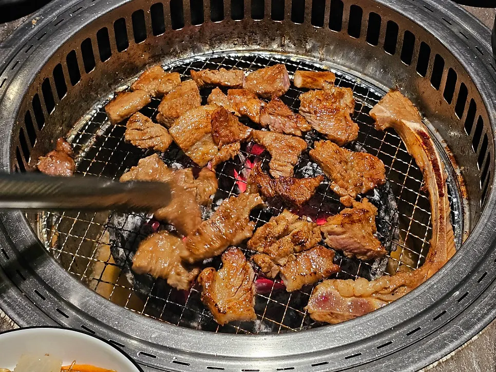 Grill with marinated pork ribs cooked by staff