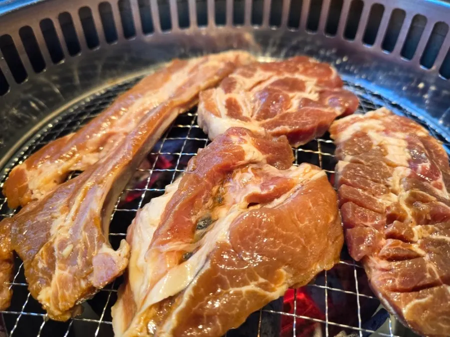 Seasoned ribs soaked with sauce alongside side dishes