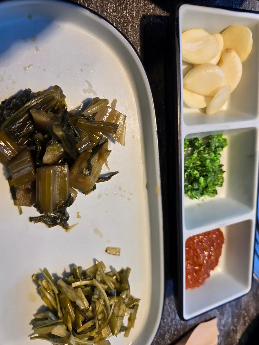 Yangnyeom galbi and side dishes over the charcoal grill