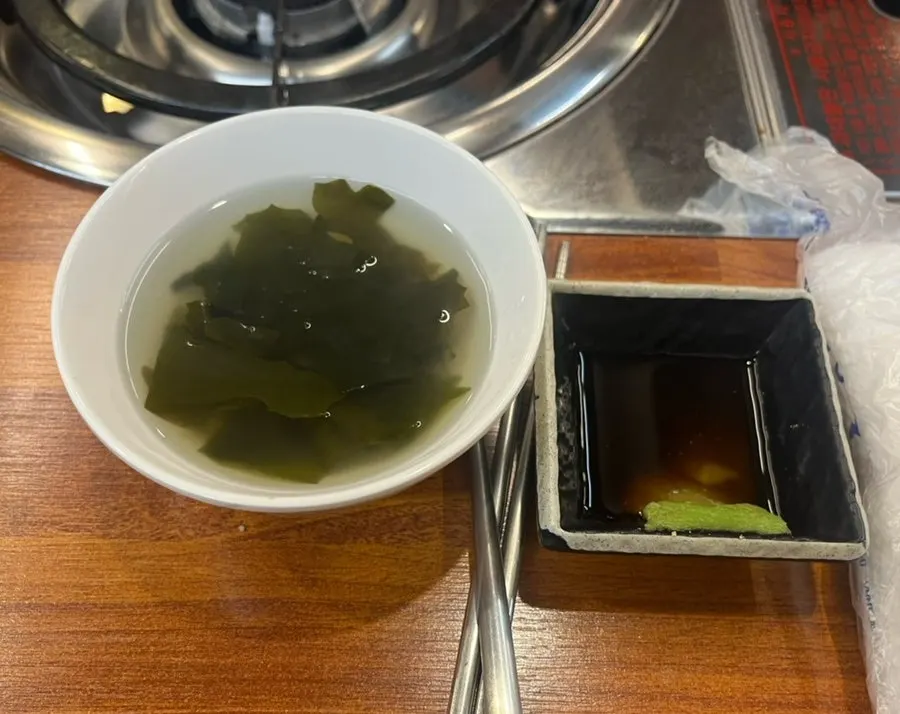 A bowl of seaweed soup served as a side